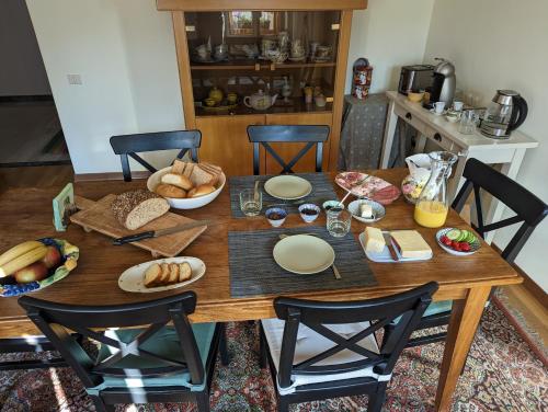 a wooden table with bread and bowls of food on it at Villa Vittorio in Forno di Zoldo