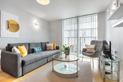 a living room with a couch and a table at Stunning Apartment with Underground parking! in London