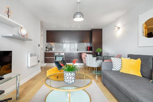 a living room with a couch and a table at Stunning Apartment with Underground parking! in London