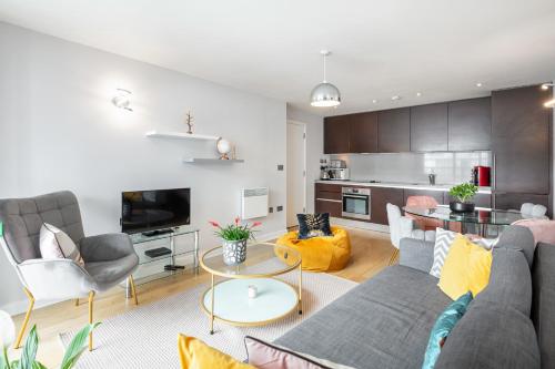 a living room with a couch and a table at Stunning Apartment with Underground parking! in London