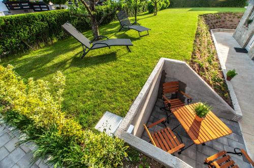 an aerial view of a park with two chairs and a bench at Apartments Ursus in Bled