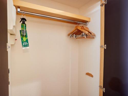 a closet with a snowboard hanging on the door at Hotel Murasakimura in Yomitan