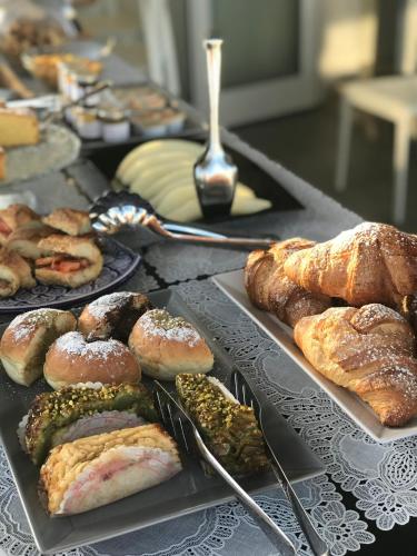 a table with several different types of pastries and bread at Imera B&B in Favignana