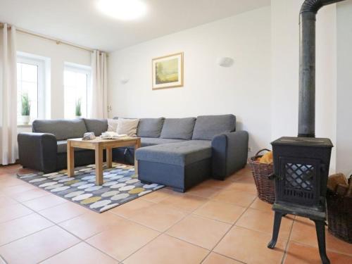 a living room with a couch and a stove at Sonnenblick Ferienhaus in Groß Schwansee