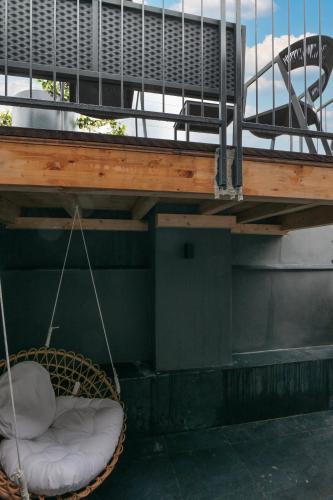 a porch swing with white cushions on a boat at PRESTIGE BOUTIQUE APARTHOTEL - Piazza Duomo View in Milan
