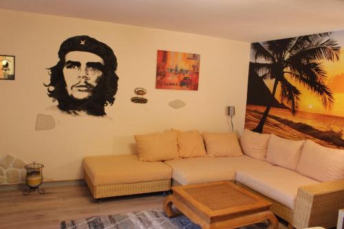 a living room with a couch and a palm tree at Casa Valentina in Neuses
