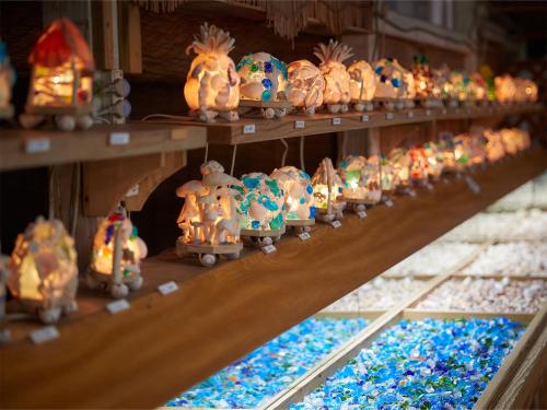 a row of shelves filled with different types of cakes at Hotel Murasakimura in Yomitan