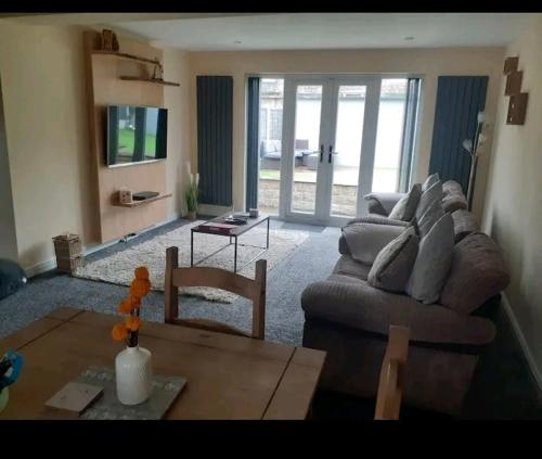 a living room with a couch and a table at Alexandra place Skipton child and dog friendly in Skipton