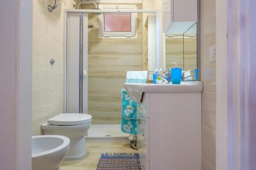 a bathroom with a toilet and a sink and a mirror at Casa tra cielo e mare in Salento in San Foca