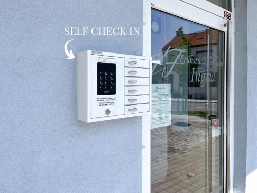 a door with a self check in sign on it at Frühstückspension Ingrid in Neutal