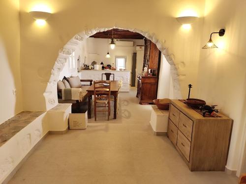 a kitchen and dining room with an archway in a house at Orania, heaven in Mykonos in Agios Sostis Mykonos
