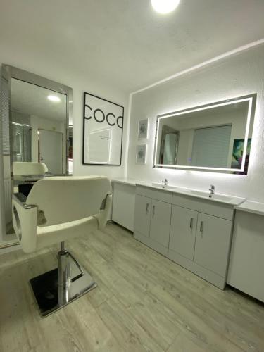 a bathroom with a mirror and a sink at Entire House for Solo travellers o work trips in Bournemouth