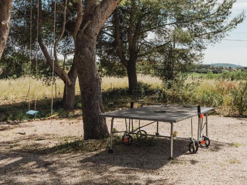 a ping pong table in front of a tree at Llucamar Villa in Sant Llorenç des Cardassar