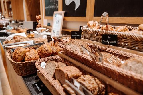 a display of breads and pastries in a bakery at Klosterhof – Alpine Hideaway & Spa in Bad Reichenhall