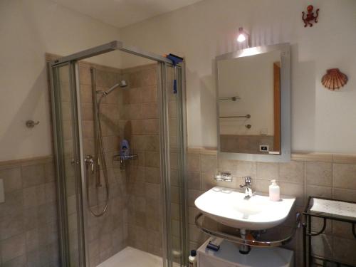 a bathroom with a shower and a sink and a mirror at CASA ALLA CASCATA House by the Waterfall and Garden of Senses in Maggia