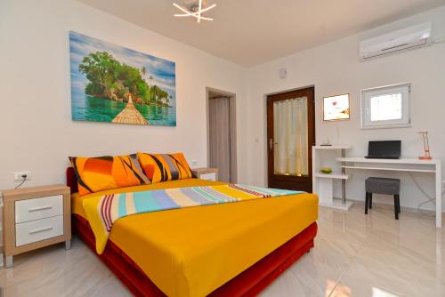a bedroom with a yellow bed and a desk at Apartments Mala Vala 925 - adapted in Fažana
