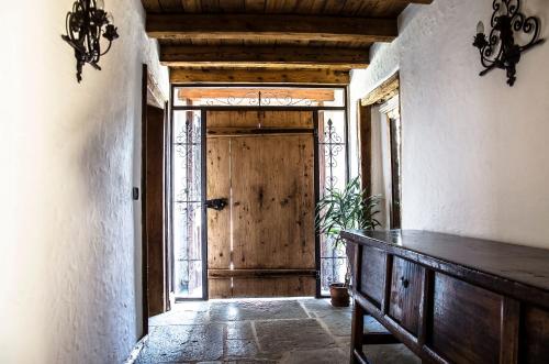 an entrance to a room with a wooden door at B&B Rossodisera in Domegge di Cadore