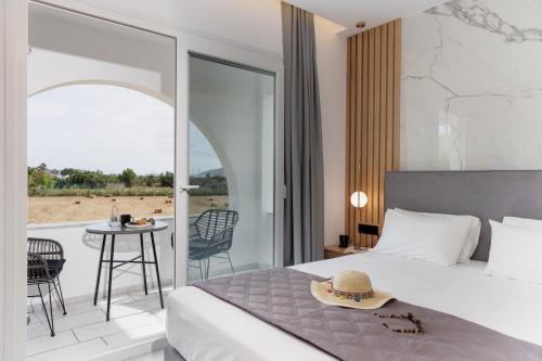 a bedroom with a bed and a patio with a table at Asterias Studios in Agia Anna Naxos