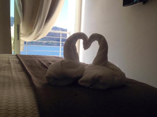 two swans making a heart on a bed at A Lago in Marone