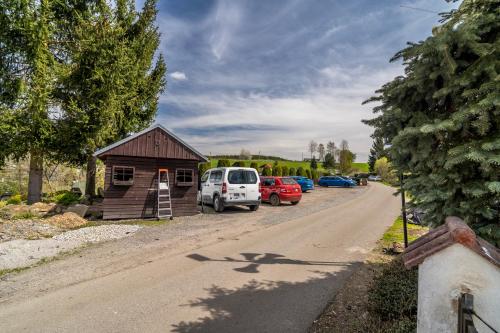 a small building with cars parked on the side of a road at Pension Regina in Český Krumlov