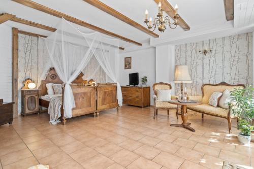 a bedroom with a bed and a table and chairs at Pension Regina in Český Krumlov