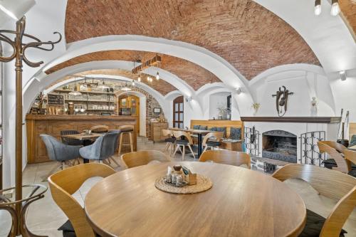 a restaurant with tables and chairs and a fireplace at Pension Regina in Český Krumlov