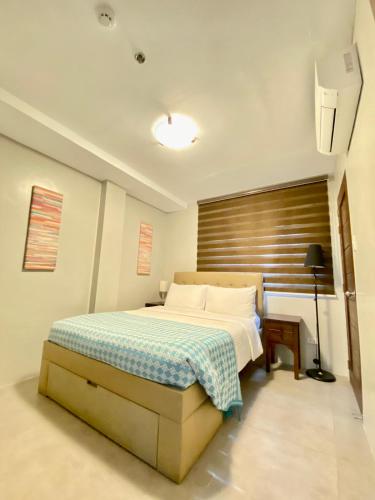 a bedroom with a bed with a wooden headboard at Paradores de Vigan in Vigan
