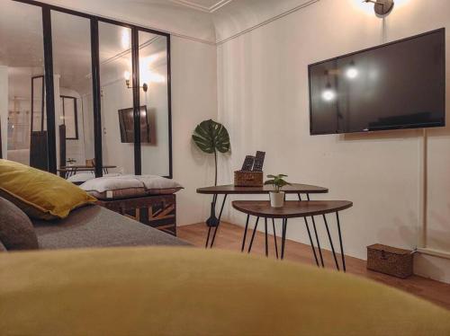 a living room with a flat screen tv on the wall at Joli appartement rénové dans le centre proche gare in Marseille