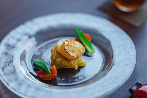 a plate with some food on a table at SEKIYA RESORT Bettei Haruki in Beppu