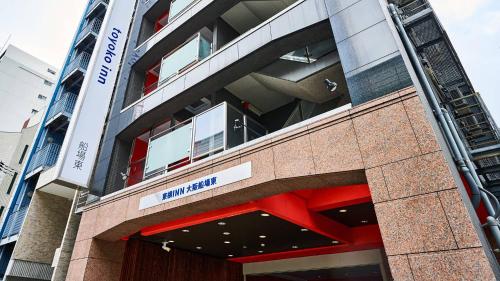 a building with a sign on the side of it at Toyoko Inn Osaka Semba Higashi in Osaka