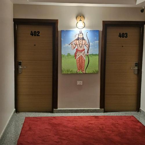 a hallway with two doors and a painting on the wall at Hotel Krishna Kathmandu in Kathmandu