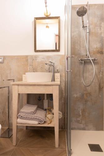 a bathroom with a sink and a shower at Le camere di Olivia in Ravenna