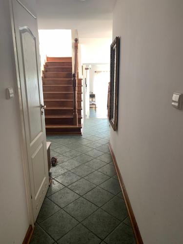 a hallway with a door and a mirror and stairs at Willa 250 M z basenem, jacuzzi, ogrodem , tarasem oraz 2 hektary sadu , kominek i inne atrakcje in Buszkowice
