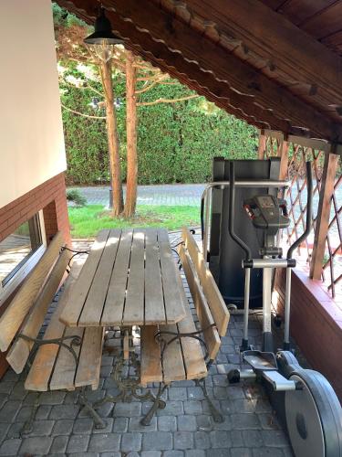 a picnic table and a grill in a pavilion at Willa 250 M z basenem, jacuzzi, ogrodem , tarasem oraz 2 hektary sadu , kominek i inne atrakcje in Buszkowice