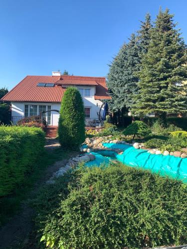 a house with a river in the yard at Willa 250 M z basenem, jacuzzi, ogrodem , tarasem oraz 2 hektary sadu , kominek i inne atrakcje in Buszkowice