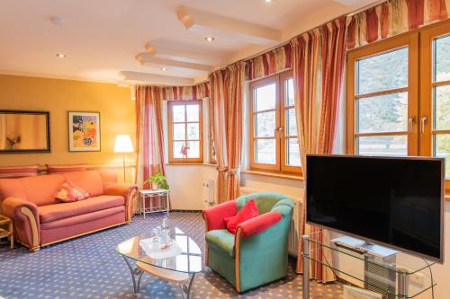 a living room with a large flat screen tv at Hotel Weiler in Oberwesel