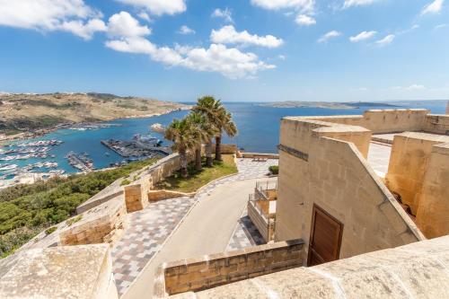 a view from the top of a building looking out over the ocean at Getaway Npetto Gozitan Villa - Happy Rentals in Mġarr