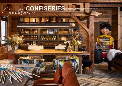 uma capa de revista de um quarto com mesa e cadeiras em Chalet Alpen Valley, Mont-Blanc em Combloux