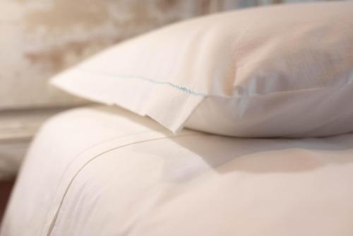 a pillow sitting on top of a white couch at Le camere di Olivia in Ravenna