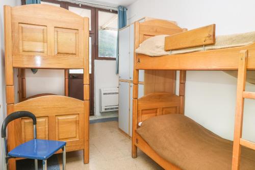 a room with bunk beds and a desk and a chair at HI Hostel Dubrovnik in Dubrovnik