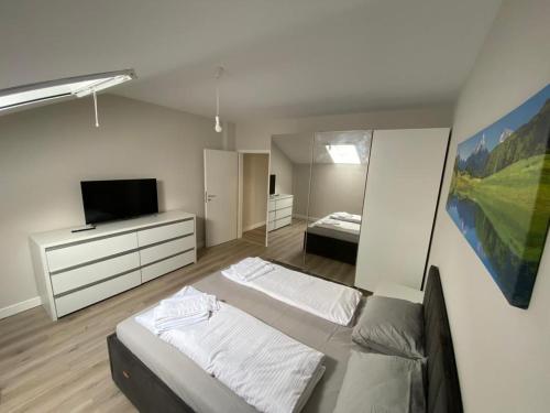 a large room with two beds and a television at Gaga Residence 15 in Timişoara
