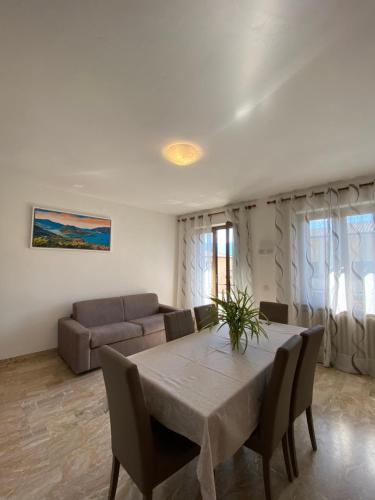 a living room with a table and a couch at Casa Ahmati Borgo Vesio in Tremosine Sul Garda