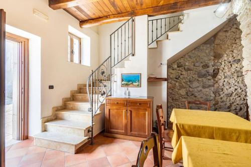 a living room with a staircase and a table at Luxury Accommodation in Santa Domenica