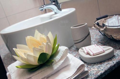 a bathroom counter with towels and a sink at MilanoRooms Bacone Self Check-in in Milan