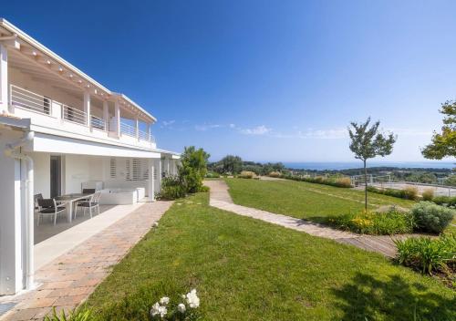 a view of a house with a lawn at Coppa Carrubo Residenza in Vieste