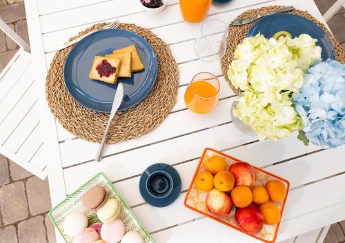 a table topped with plates of food and drinks at Coppa Carrubo Residenza in Vieste