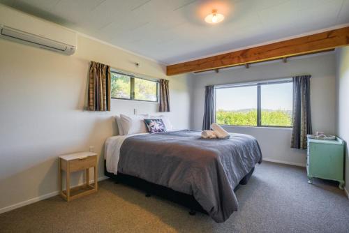 a bedroom with a bed and a window at Tranquil Retreat in Taupo