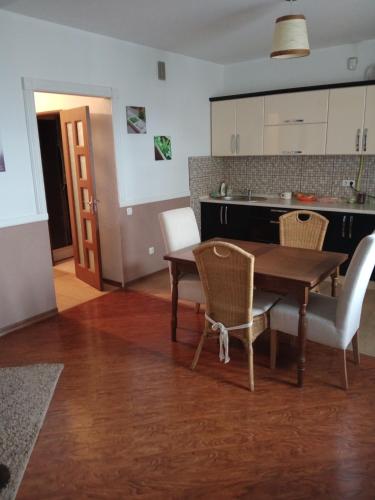 a kitchen and dining room with a table and chairs at modern home in Chişinău