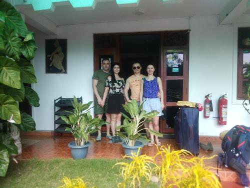 a group of people standing in a room with plants at Ella Jayamali Holiday Pavilion in Ella