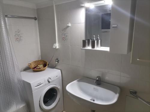 a bathroom with a washing machine and a sink at Vaso holidays in Alexandroupoli